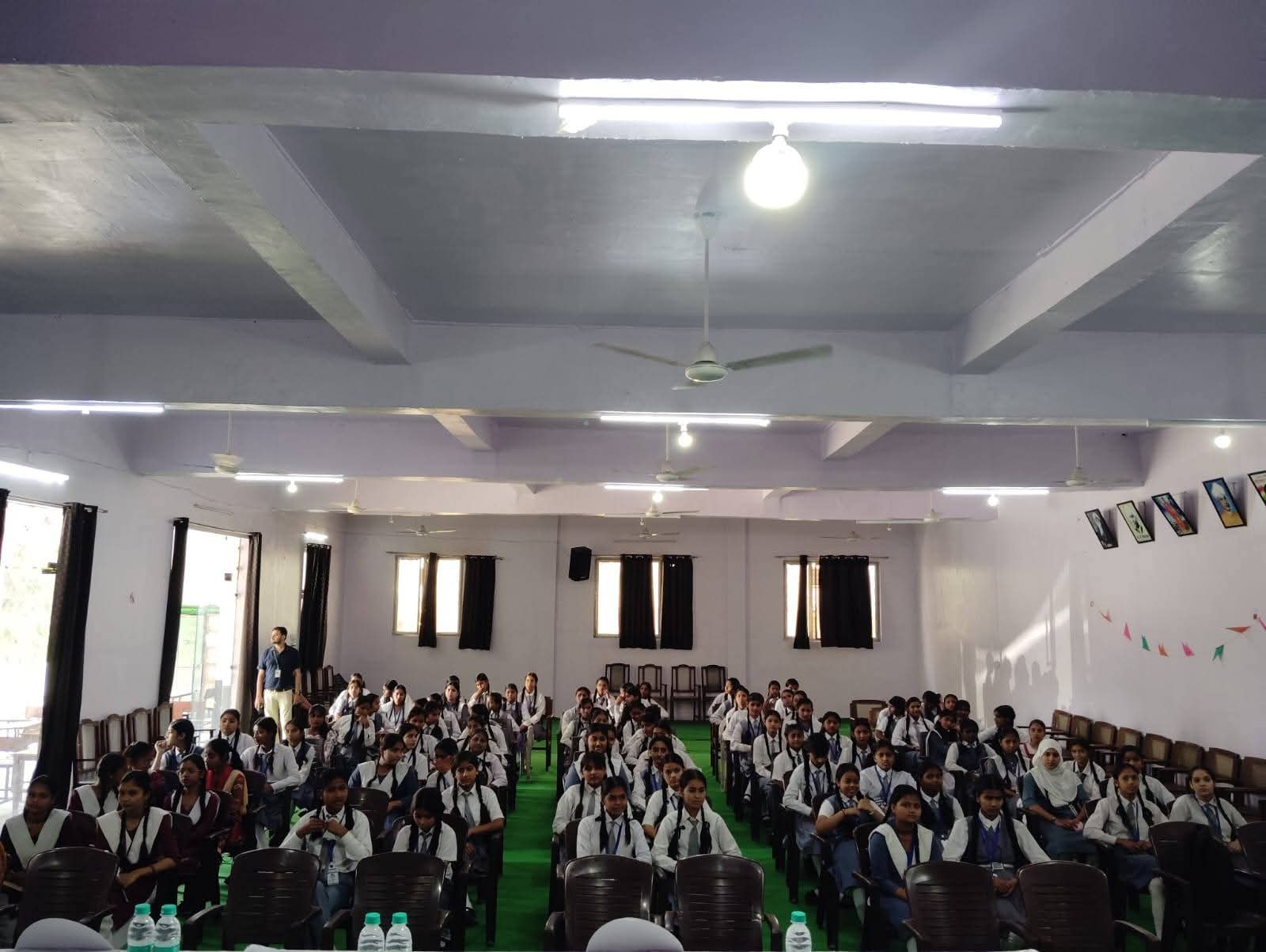 Large gathering of girls in school uniform for SHE ROCKS workshop